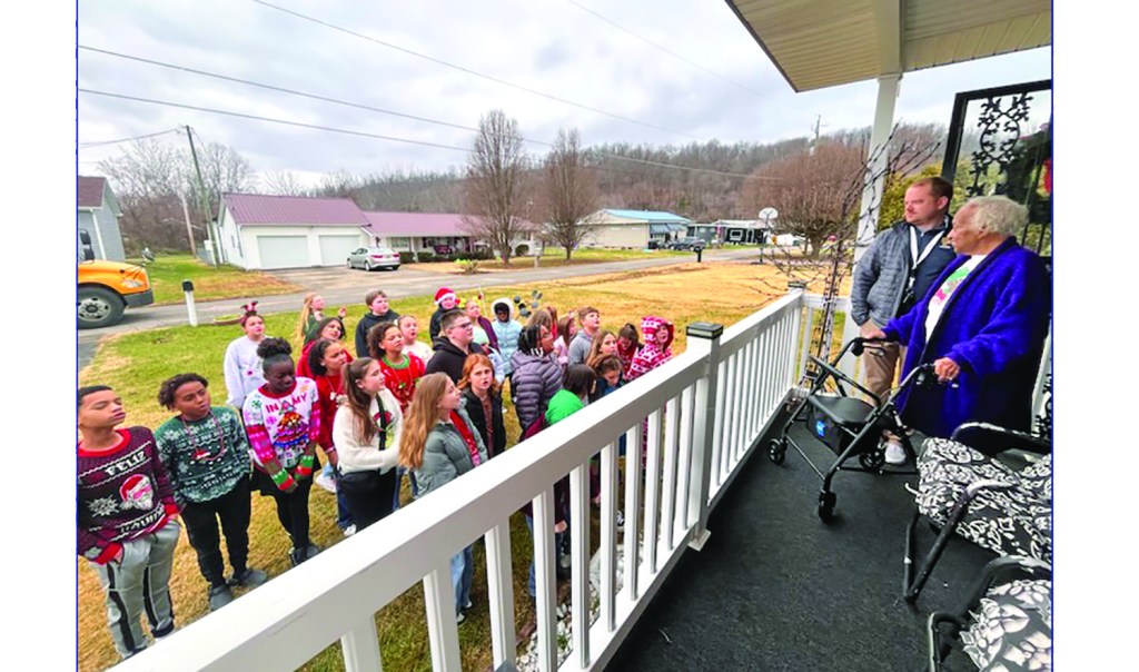 Burlington students sing carols for former librarian